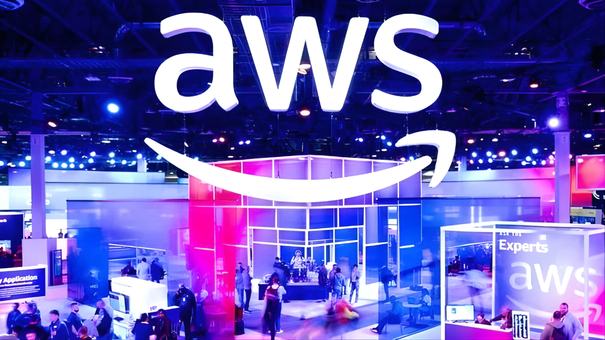 AWS booth at a tech conference with visitors exploring cloud and AI displays under bright event lighting