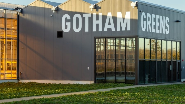 Gotham Greens greenhouse exterior with large branded signage and glass facade